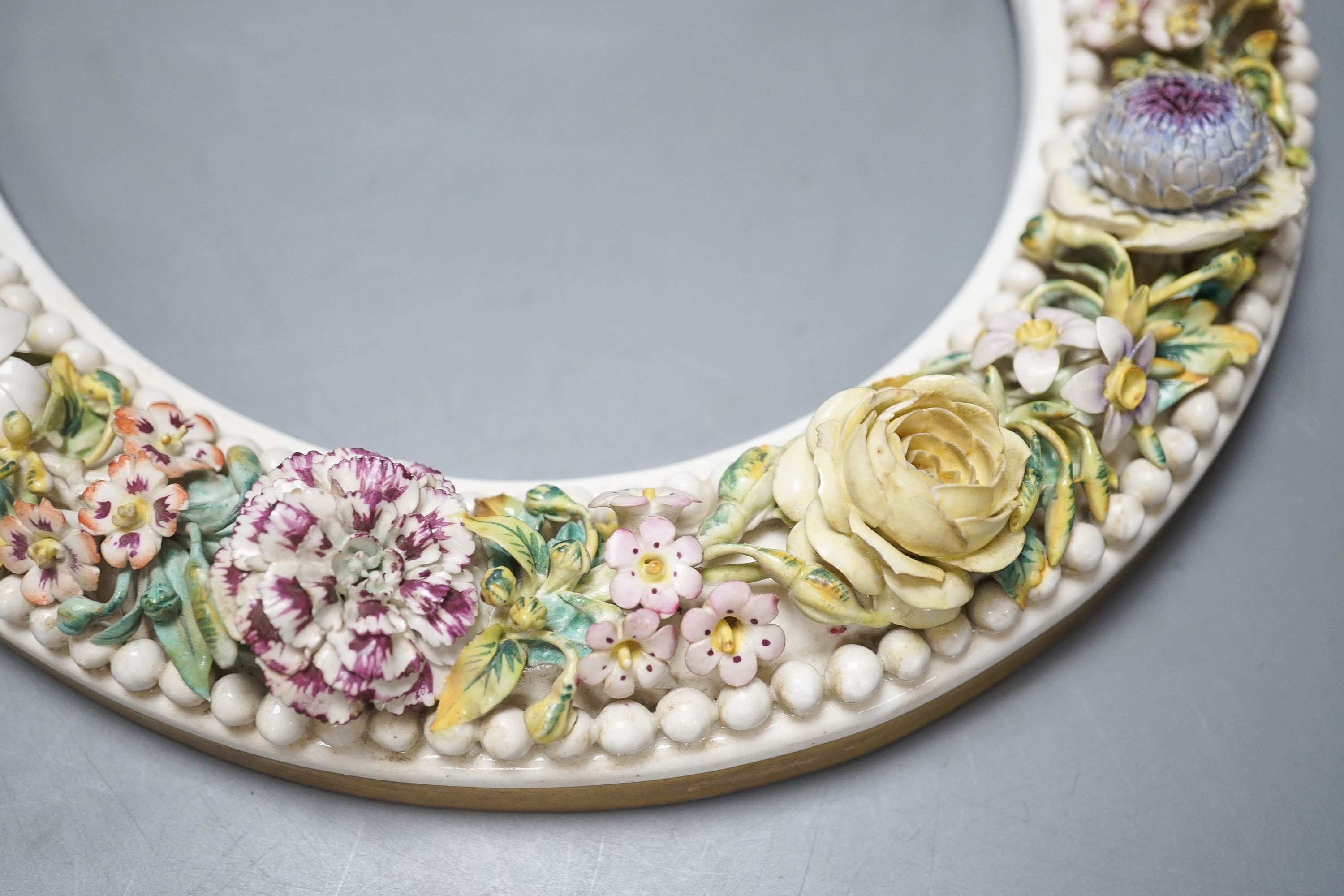 A 19th century English porcelain floral encrusted oval frame 32cm